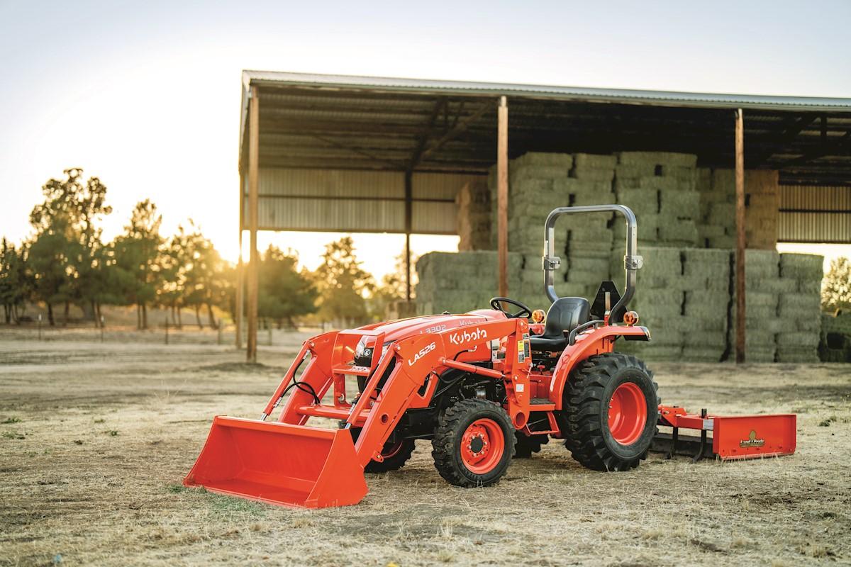 Tractor in front of hay shed
