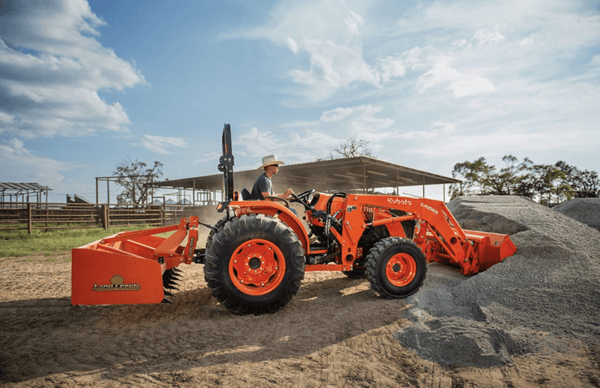 Man moving gravel with front end loader