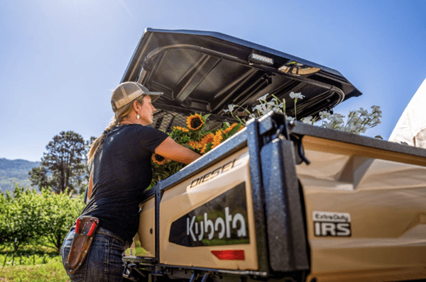 Close-up of woman loading up cargo bed on Utility Vehicle