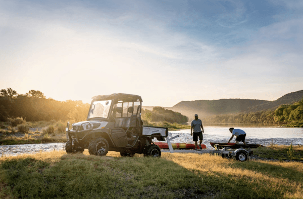 RTV next to a lake with people loading up kayaks