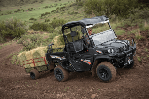 RTV driving on muddy terrain with a full payload