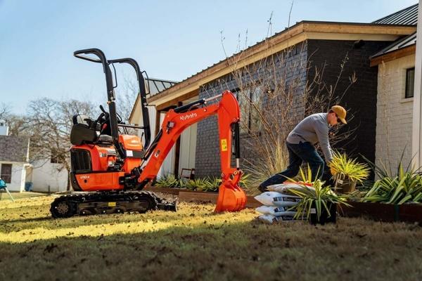 Man using excavator for landscaping