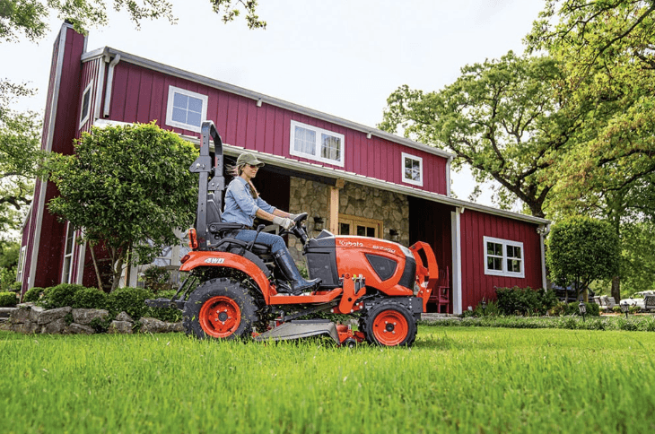 Woman driving a sub-compact behind a house