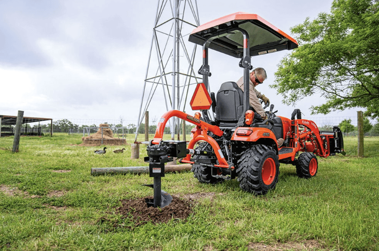 Man using an auger attachment