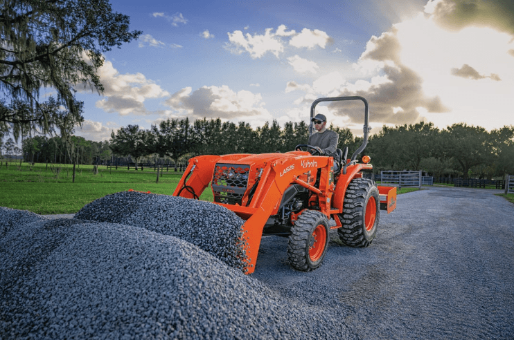 Tractor scooping up from pile of gravel