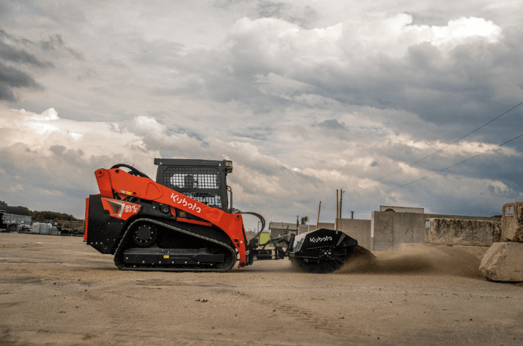 Track Loader using a sweeper attachment