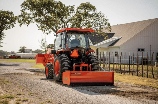Tractor with box blade rear attachment