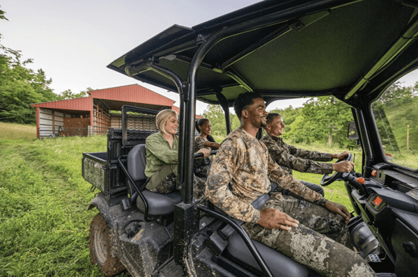 Hunting crew having fun riding in an RTV