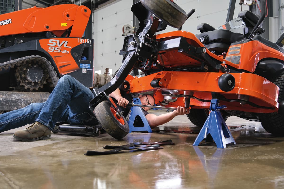 Kubota service tech repairing a zero-turn mower